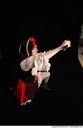 DARINA KNEELING POSES WITH DAGGER 